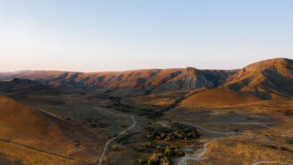 The Shigaraki foothills at golden hour, looking toward the Tetujin brewery in the valley